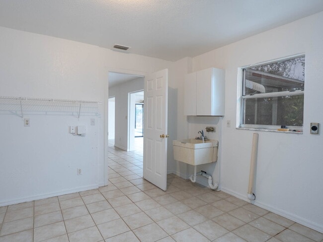 Building Photo - Recently painted 4BR/3BA home with tile floors throughout, fenced yard, detached garage, and prim...