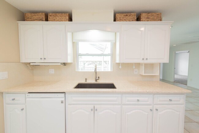 Building Photo - Live the ultimate Space Coast waterfront lifestyle at this stunning beachside canal home in Satel...