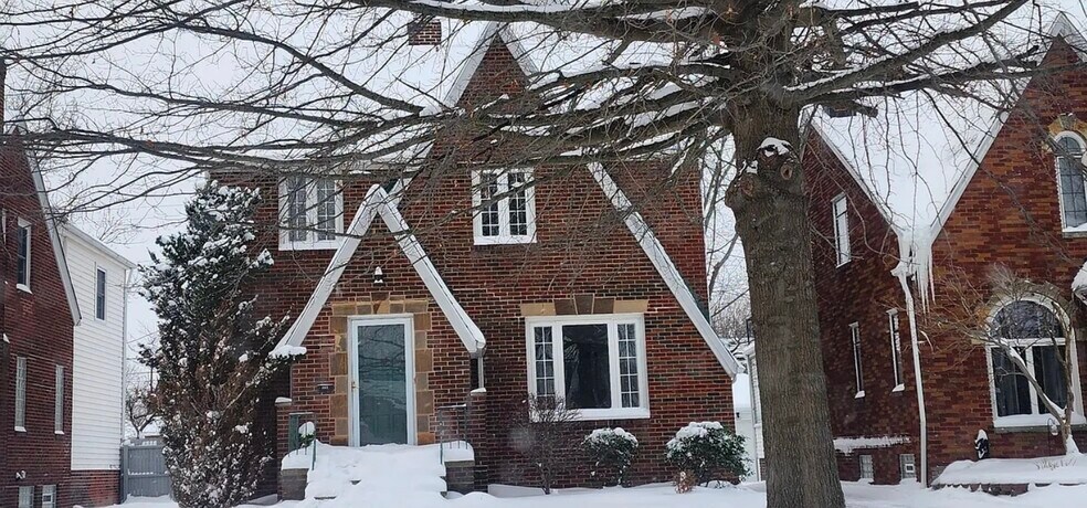 Just steps from Lake Erie, the home is presented in a quiet winter setting. Timeless architecture, a - 90 E 216th St