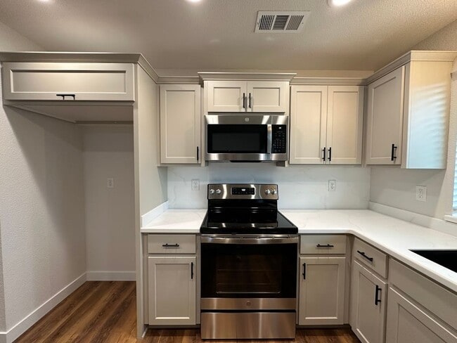 Building Photo - Updated Home with Island Kitchen, LVP Flooring, and Yard Care Included!