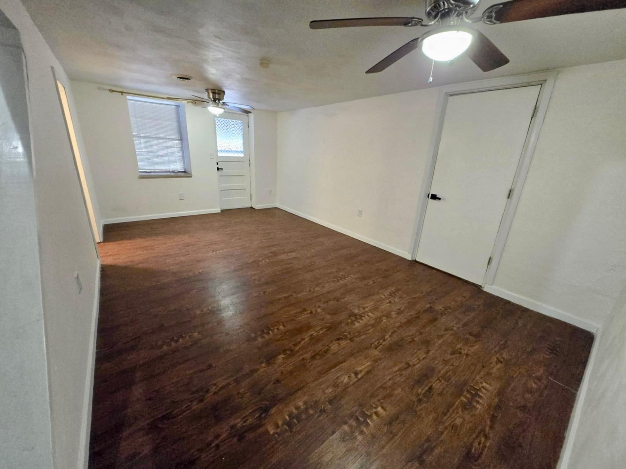 Den leads to back door, downstairs bathroom, laundry room, and second bedroom - 2612 Louisiana Ave