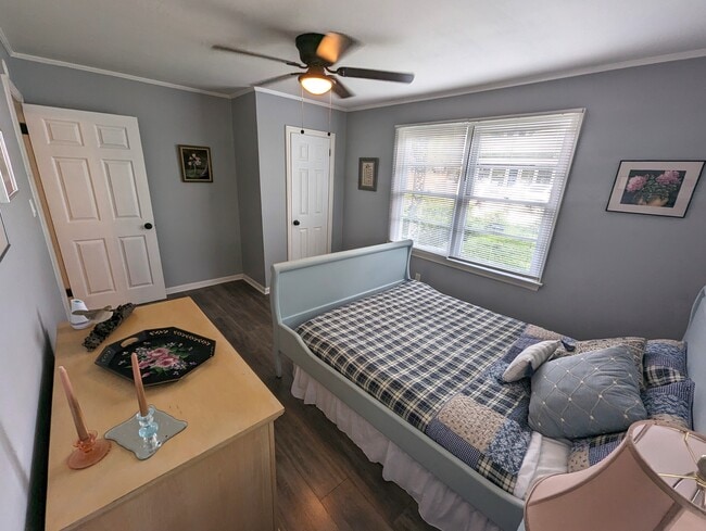 Bedroom 2 is warm and cozy. Queen bed, original art and a closet. - 4107 Crane St