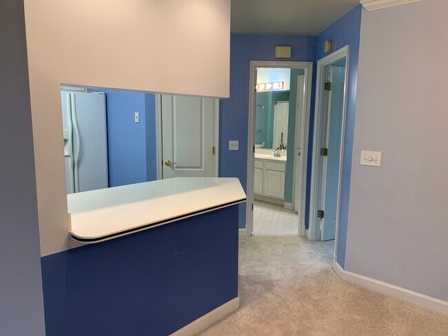 Kitchen pantry closet, bathroom and the door to master bedroom with balcony - 6916 Fairfax Dr