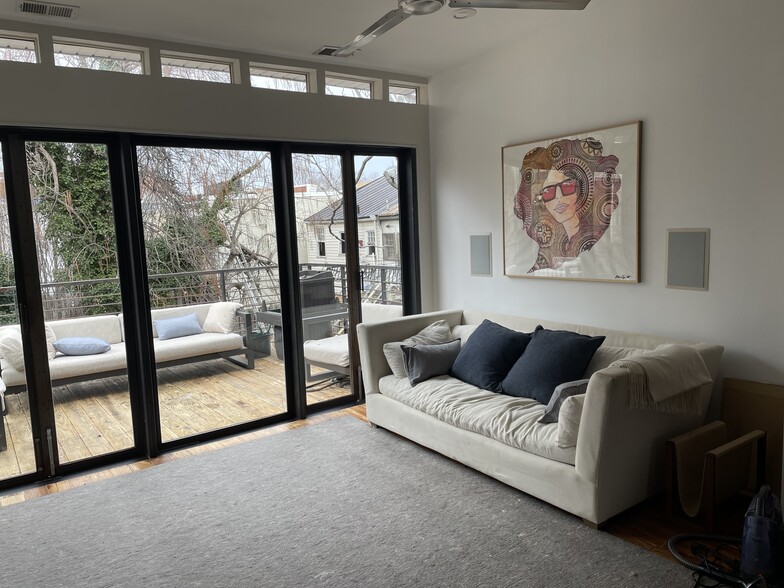 High ceilings with Restoration Hardware sofa and cashmere pillows opens out to large deck with Restoration Hardware outdoor furniture - 1003 P St NW