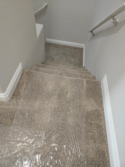 looking down the stair case - 8799 Horizon Wind Ave