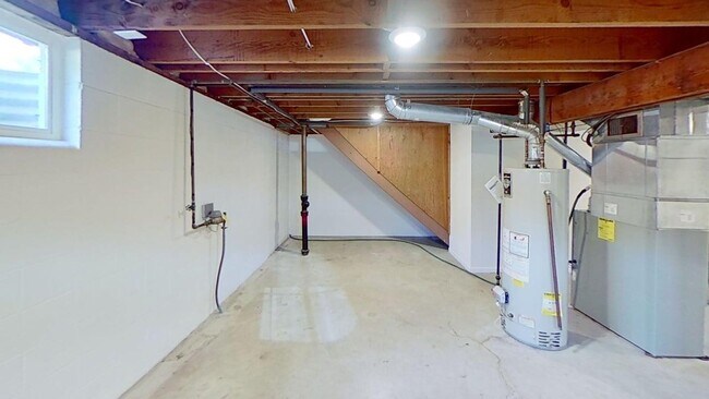 Building Photo - Updated two bedroom duplex, new stainless steel appliances, garage, and hardwood floors
