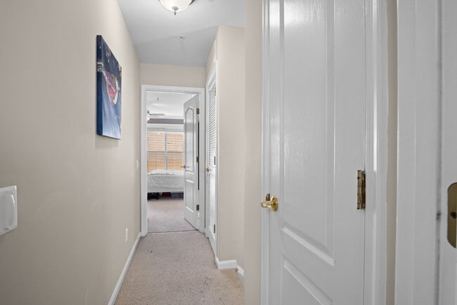 Building Photo - This inviting two-level townhome offers comfort and style, featuring gleaming hardwood floors on ...