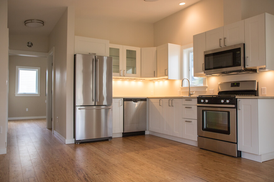 Kitchen with under-cabinet lighting, perfect for entertaining. - 5239 NE Mason St