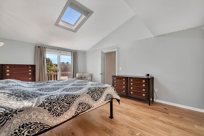 Primary bedroom with walk out balcony and skylight - 1500 Cambridge Dr