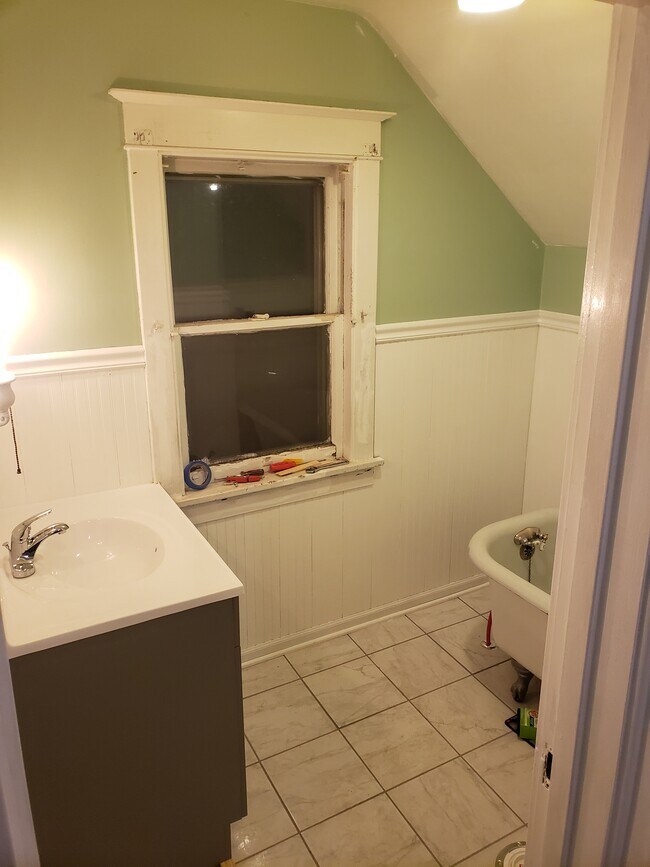 Upstairs Bathroom: Brand new flooring and vanity with claw foot tub - 522 N 42nd Ave W