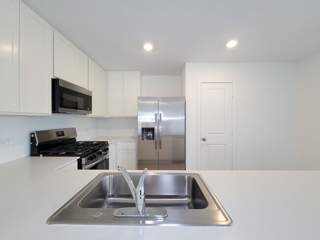 Building Photo - This great new single-story design makes smart use of the space available. At the front are all t...