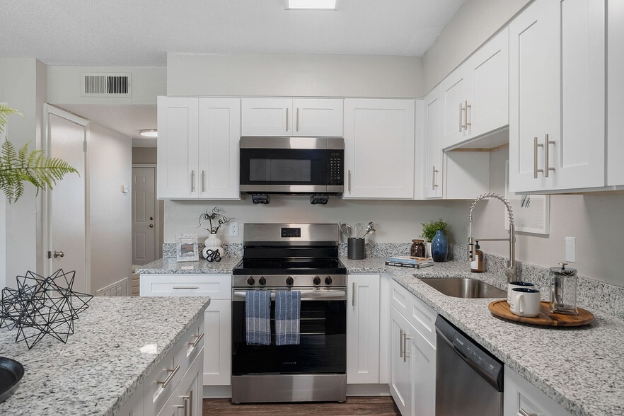 Kitchen with granite counters, stainless appliances, and modern cabinetry - Blakely