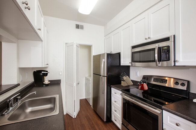 Classic Package I kitchen with stainless steel appliances, white cabinetry, laminate countertops, and hard surface flooring - eaves Dublin