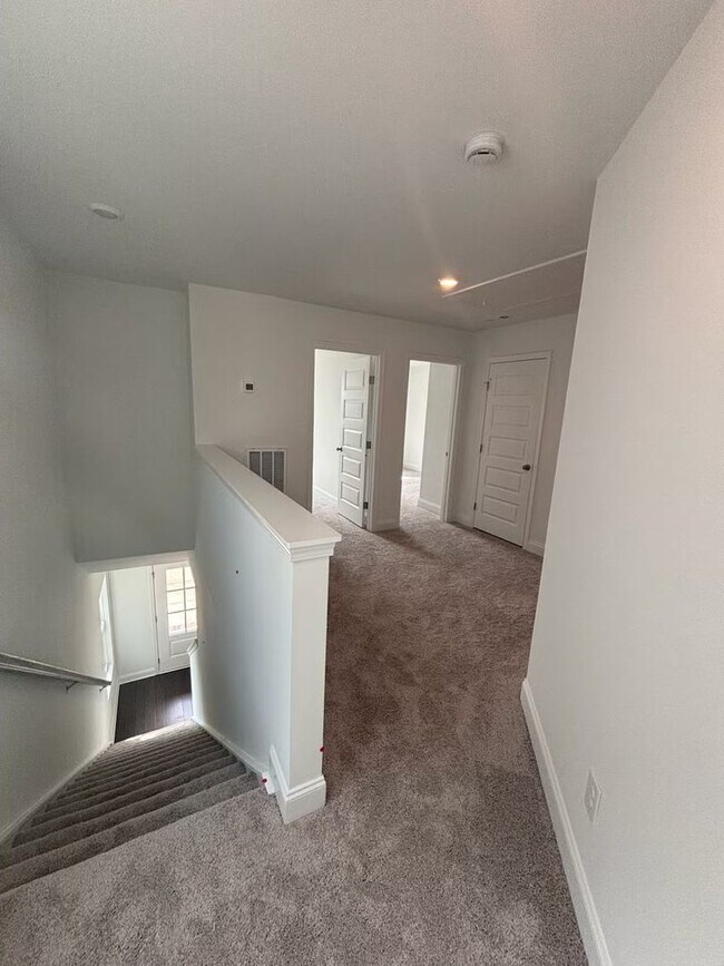 Building Photo - **BE THE LUCKY ONE TO LIVE IN THIS 2024-BUILT END-UNIT TOWNHOME IN A RESORT-STYLE COMMUNITY**