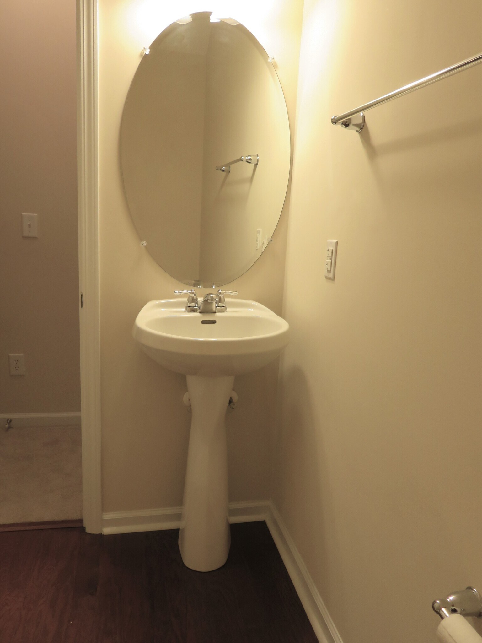 Downstairs Half Bath off Great Room w pedestal sink & wood floor - 2496 Stadium Dr