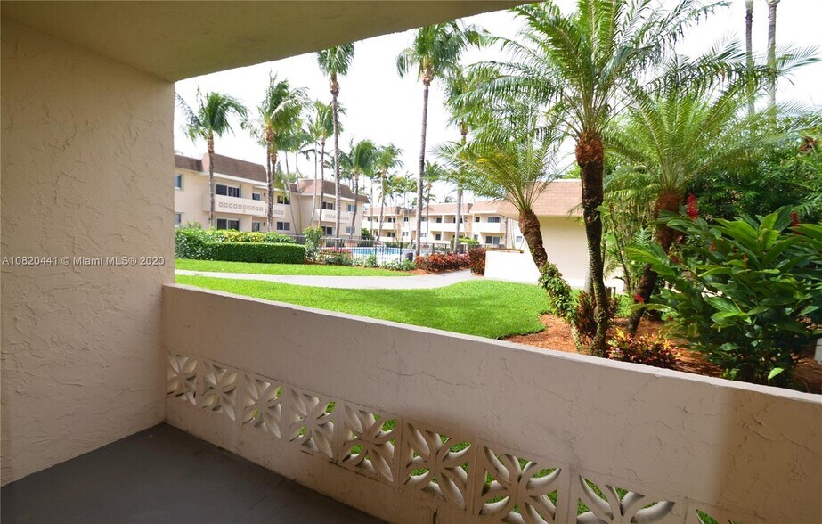 Lush landscaping with pool view from the living room and porch - 14500 SW 88th Ave