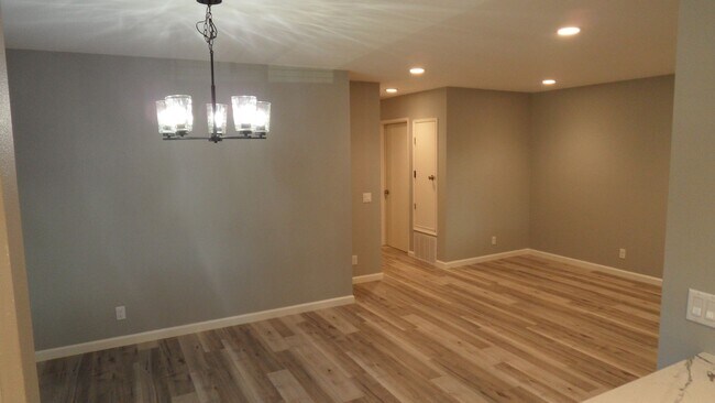Building Photo - REMODELED 2BR; 1BA end unit condo w/ 1 car garage & 1 parking space
