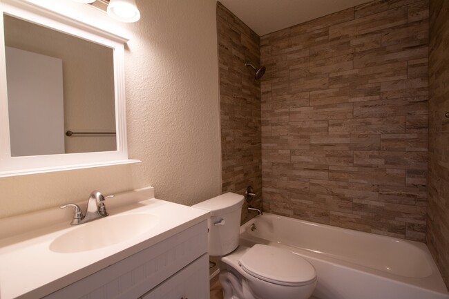 Updated bathroom with brand new tile surround bathtub - 1222 E Harry St