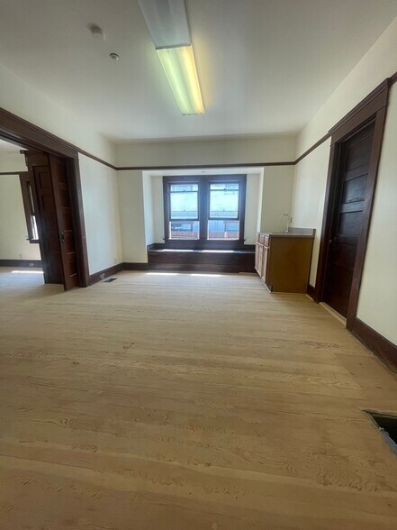 Second large bedroom with hardwood floors (before clear varnish application). Pocket doors. - 1135 Magnolia St