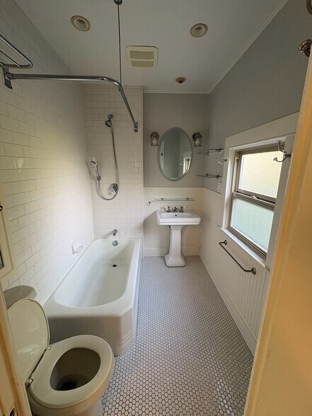 Downstairs bathroom with shower over tub - 308 14th St