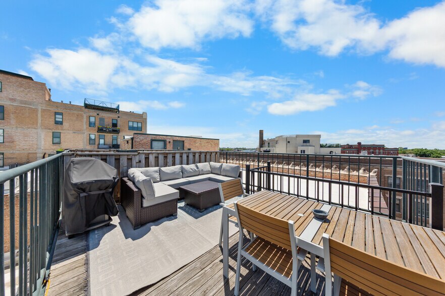 Private rooftop deck with direct access from spiral staircase in unit. - 3151 N Lincoln Ave