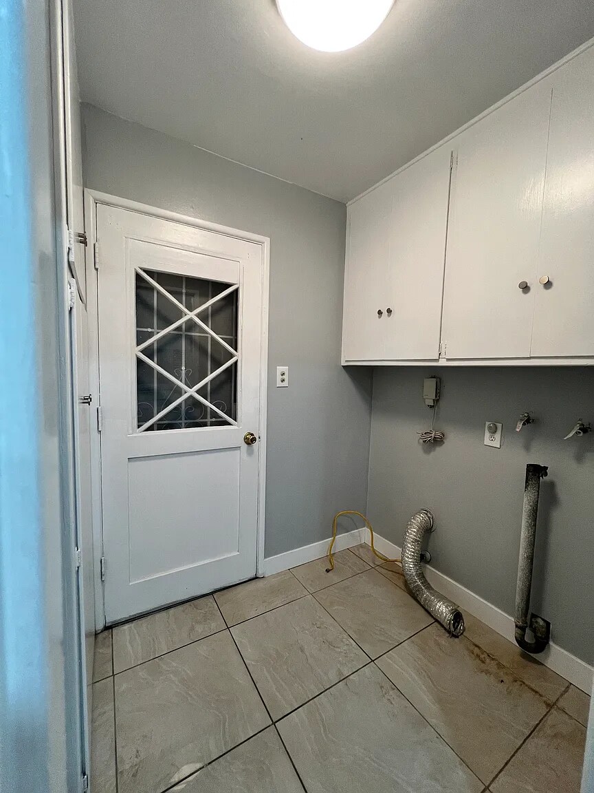 Laundry room with hookups, door to backyard - 15503 Bloomfield Ave