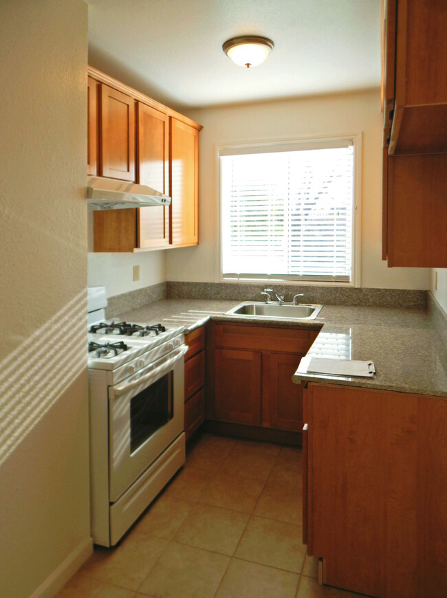 Kitchen has big window, gas stove, granite counters - St. Maarten Apartments