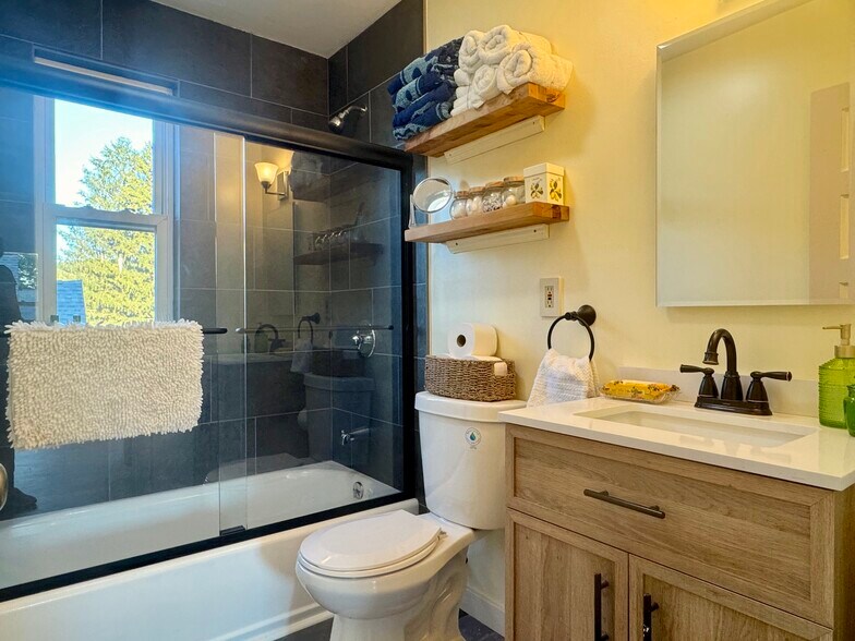 Tile tub/shower surround with new sliding door. - 98 Maple St
