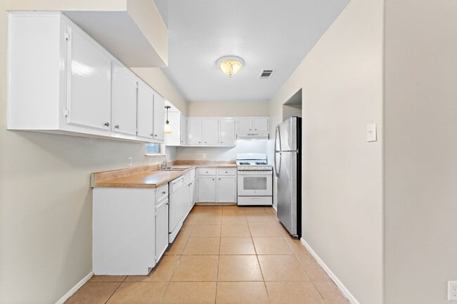 Building Photo - Beautifully remodeled 4 bedroom bath and a half with ceramic tile through out and laminate floori...
