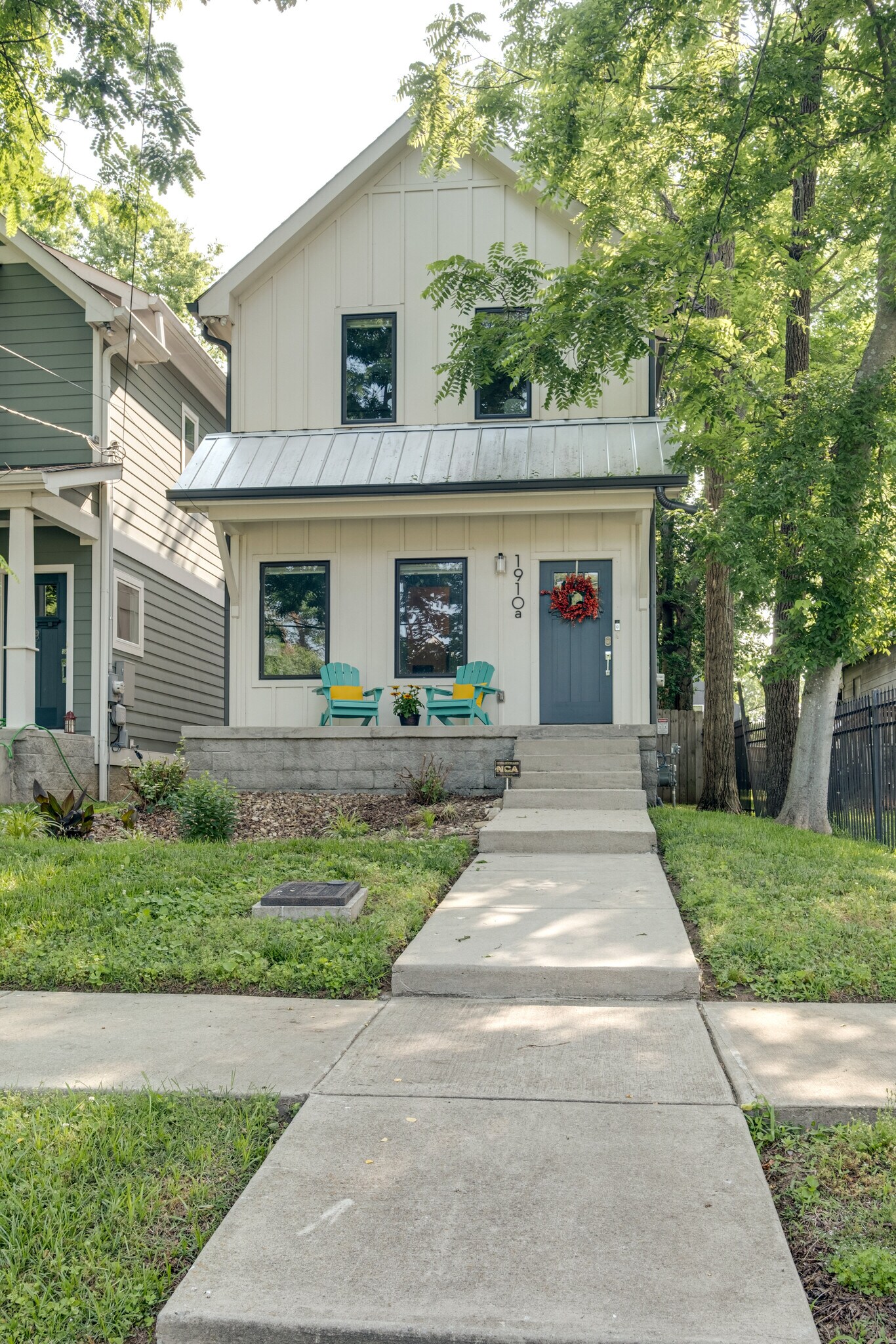Front of house with Covered porch and Adirondack seating - 1910 11th Ave N