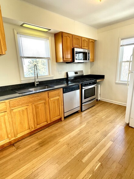 Newly renovated eat-in kitchen with granite countertops, dishwasher and microwave - 648 Valley Ave