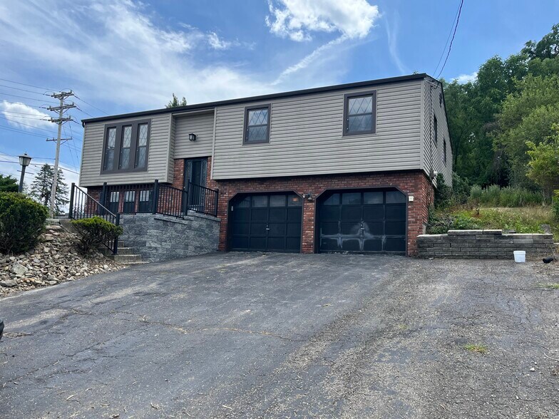 2 car garage and entry lane of parking on right side of driveway. - 608 Sangree Rd