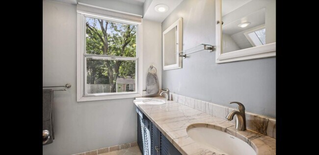 full bath w/ heated tile floors, large vanity w/ dual sinks & ample storage - 2740 Alabama Ave S