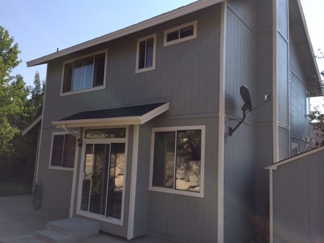 Back slider door opens to a large patio, grass and terraced backyard with fruit trees. - 3964 Glenview Terrace