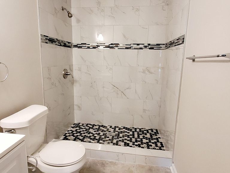 En-suite master bathroom with new walk in tiled shower. - 1300 Bay Hill Blvd.
