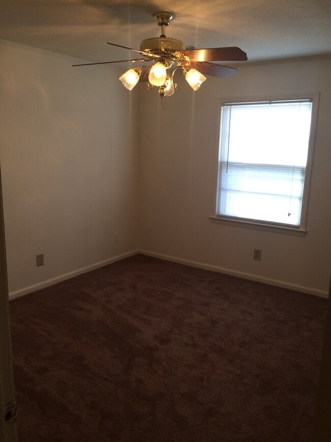 Building Photo - Brick Home with Carport & Fenced yard