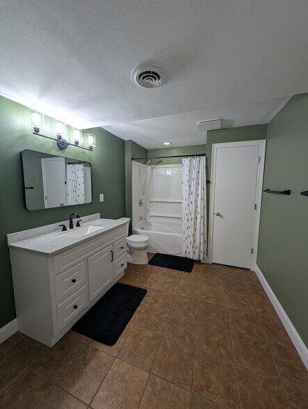 Recently updated full basement bathroom with heated tile floors and large linen closet - 518 Lexington Dr