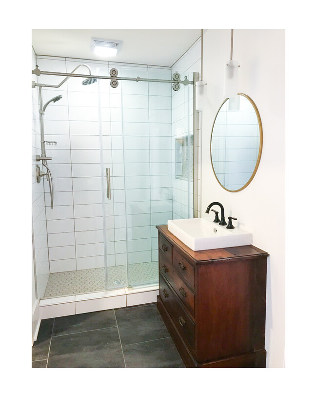 Spacious brand new tiled shower with an insert for shower toiletries, and luxurious rainfall shower head with multi function hand held sprayer. - 18 W State St