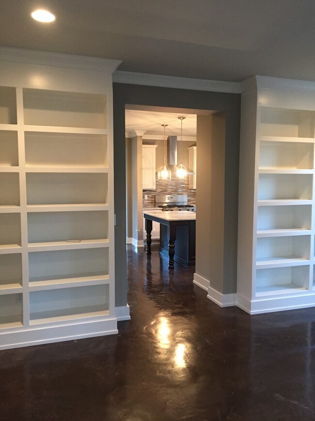 Built-in book shelves, concreat floors, and nice open floor plan that flows throughout. - 1003 Dew St