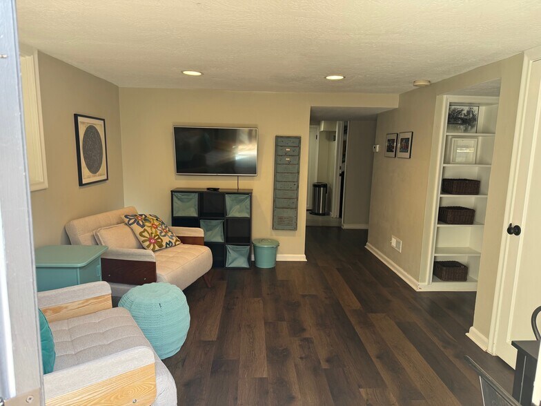 Extra storage under TV with included baskets. - 469 G St