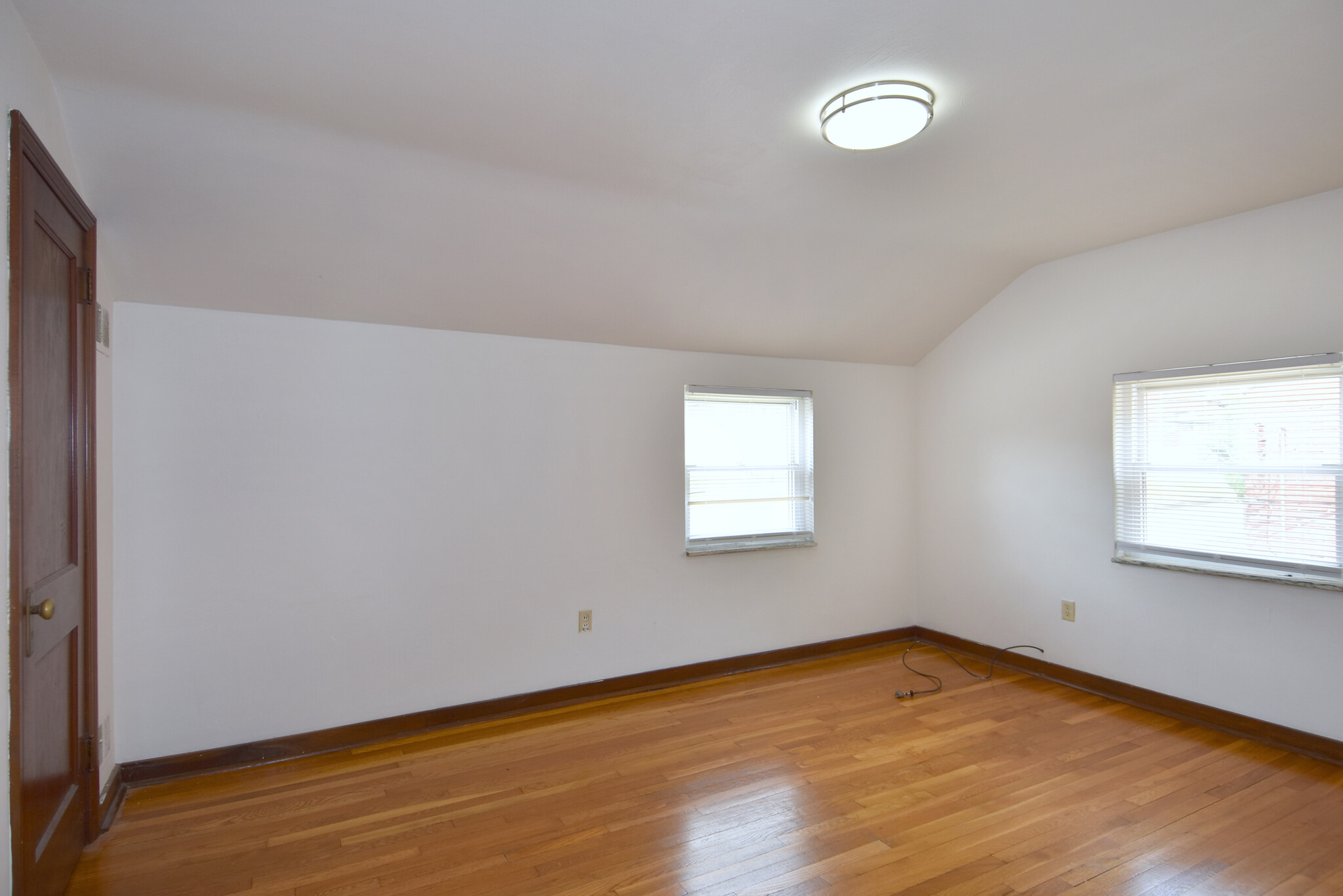 Spacious Bedroom #1 with new mini-blinds and original hardwood flooring throughout - 210 E Garden Rd