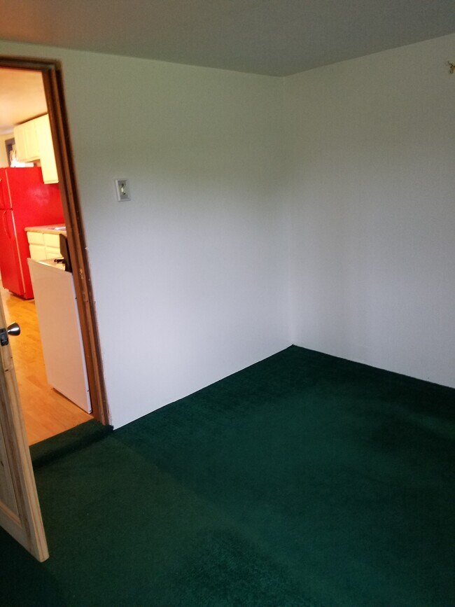 First floor Bedroom, south wall with entry to Kitchen. - 15 Goodrich St