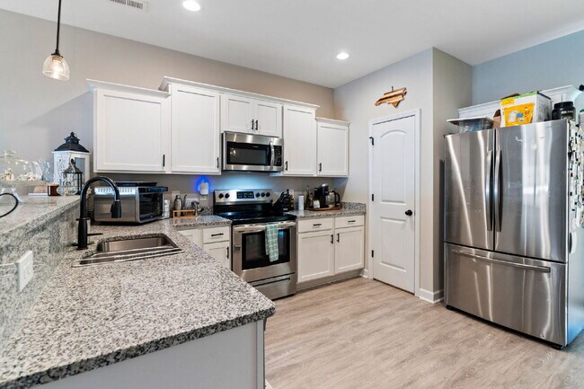 Building Photo - Available Now! Enjoy low-maintenance coastal living in this beautiful 2-bedroom, 2.5-bath townhom...