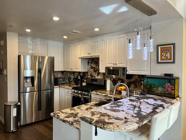 Remodeled kitchen with an exotic countertop design - 89 E Commonwealth Ave