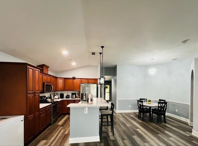 Open kitchen with modern and fully equipped, and sleek countertops - 3602 NW 55th Ln