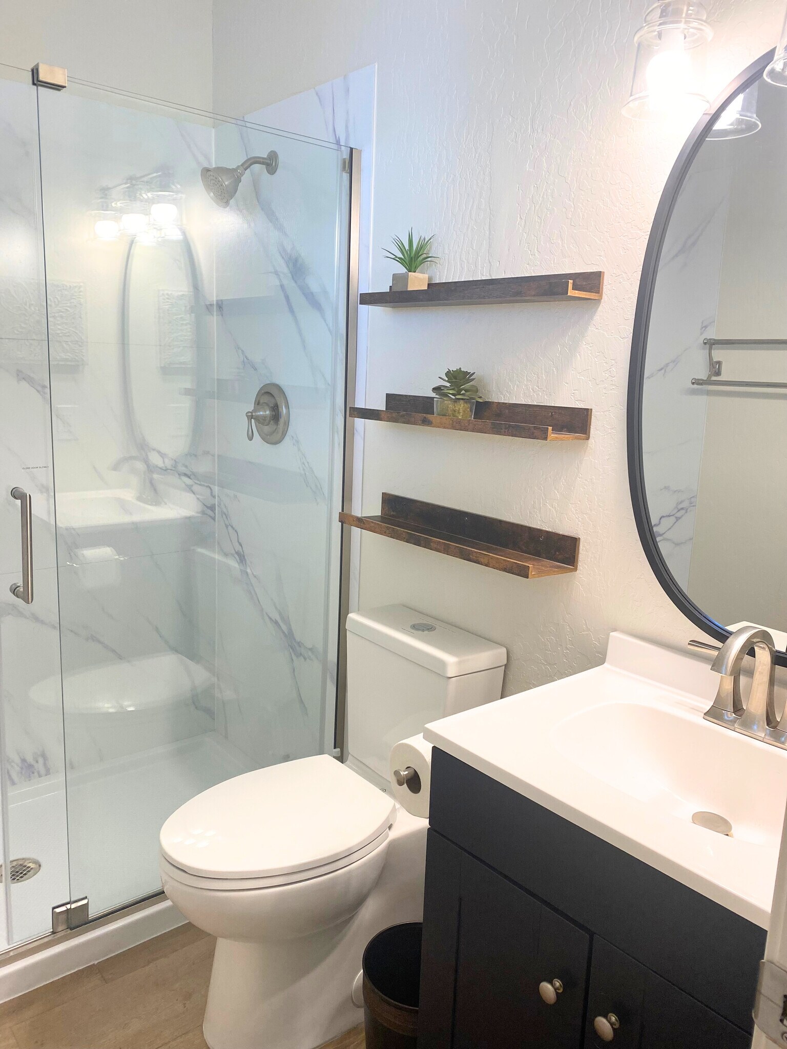 Bathroom setup featuring a stylish sink, mirror, convenient shelves-perfect for your essentials. - 1795 W 28th St