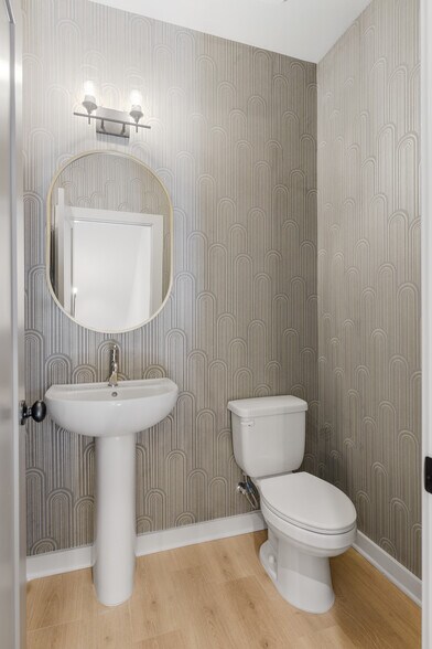 Elegant second-floor powder room with designer finishes. - 358 E Village Ln