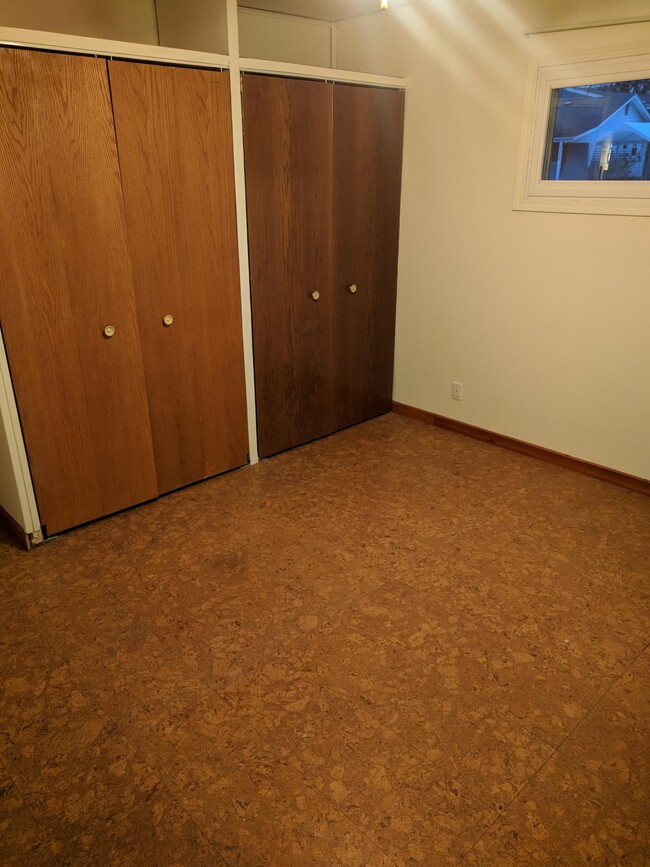 Main front bedroom has cork floors and two closets. - 4225 Sheffield Road