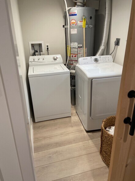 Enclosed laundry room in Clean well-lit finished basement (off camera). Huge studio space w/ storage - 5124 NE 35th Pl