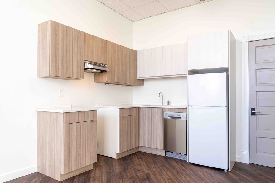 The kitchen features quartz countertops, stove, and Energy Star dishwasher and refrigerator. - 818 12th St